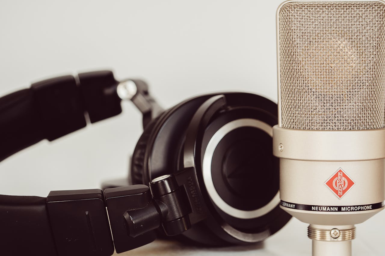 The Art of Drawing Readers In: Your attractive post title goes here Close-up of a high-quality studio microphone paired with headphones, essential for recording.