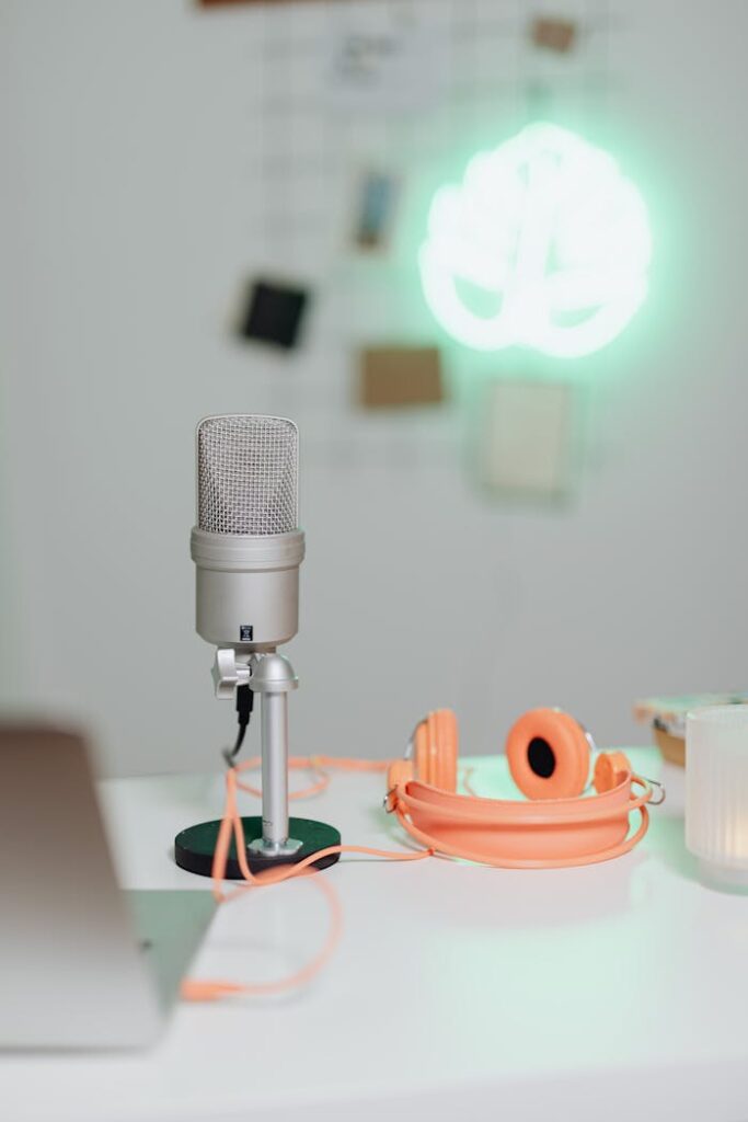 No Job, Only Business! The inspiring story of a Tailor Boy! Simple home audio setup featuring a microphone, headphones, and soft lighting for creative projects.